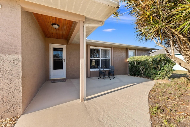 entrance to property featuring a patio