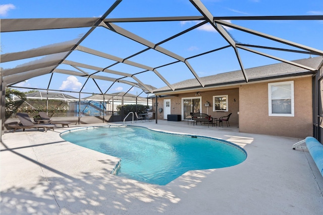 view of pool featuring a patio, ceiling fan, and a lanai