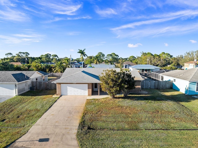 ranch-style home featuring a garage and a front yard