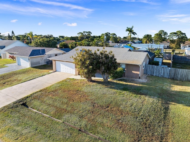 ranch-style home with a garage and a front lawn