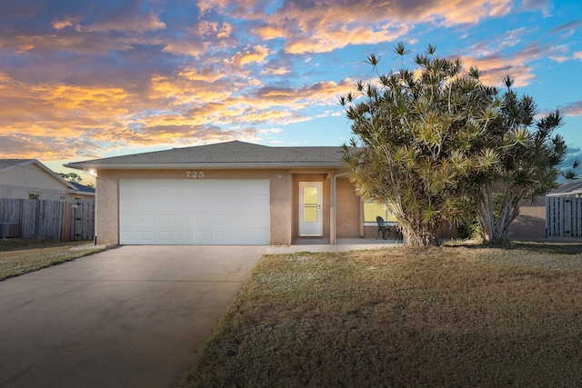 view of front of house with a garage and a lawn