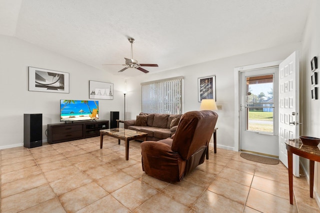 living room with light tile patterned floors, a textured ceiling, ceiling fan, and lofted ceiling