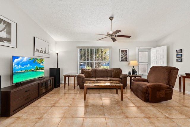 tiled living room with ceiling fan and a textured ceiling