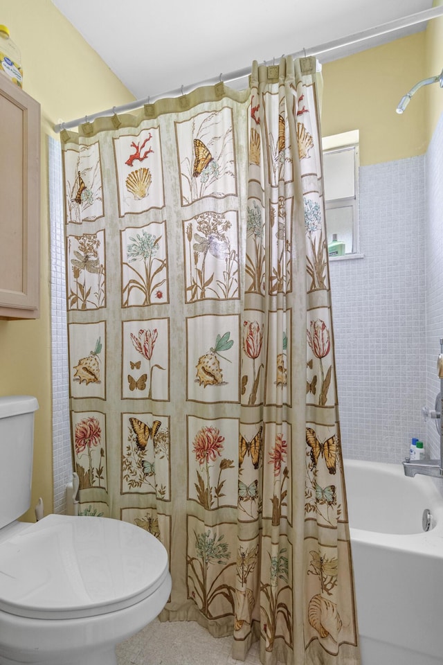 bathroom with shower / bath combo and toilet