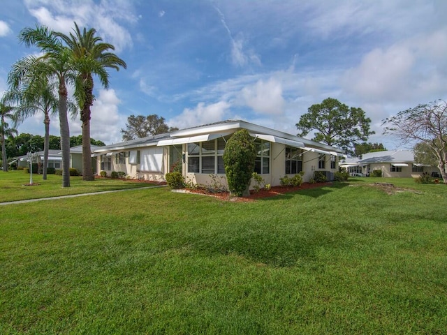 view of side of home with a yard