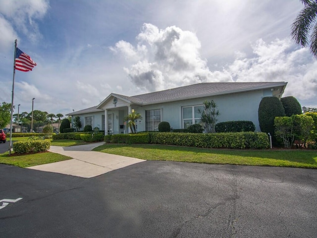 ranch-style house with a front lawn