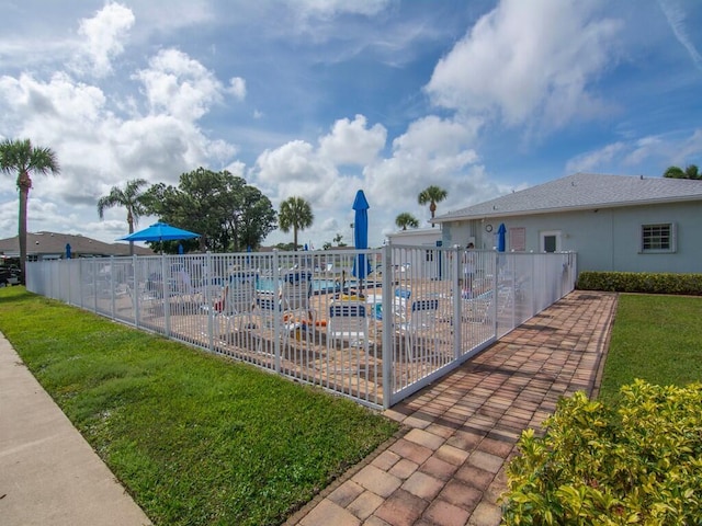 view of pool with a yard