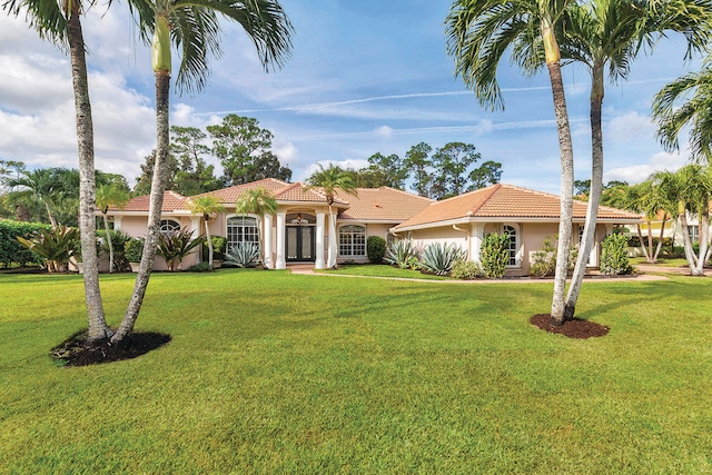 mediterranean / spanish-style home with a front lawn