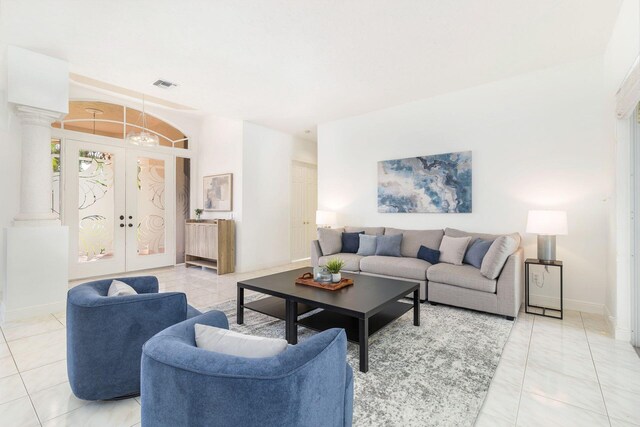 1627 Mayacoo Lakes Blvd, West Palm Beach, FL 33411 - living room with ornate columns, baseboards, light tile patterned floors, and french doors