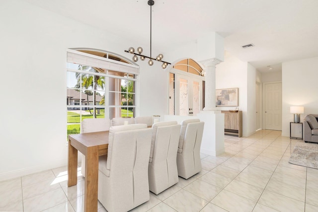 1627 Mayacoo Lakes Blvd, West Palm Beach, FL 33411 - dining area with decorative columns, light tile patterned floors, and baseboards