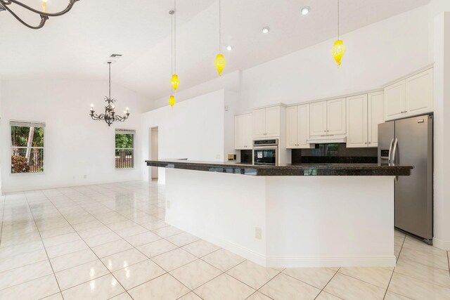 kitchen featuring sink, dishwasher, white cabinets, a chandelier, and hanging light fixtures