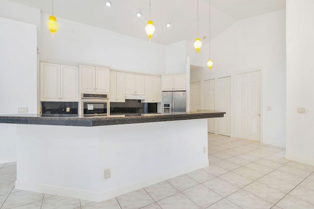 kitchen with backsplash, high vaulted ceiling, stainless steel appliances, and decorative light fixtures