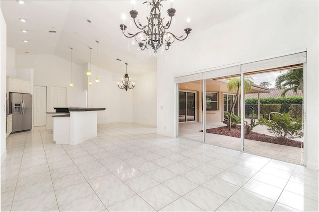 unfurnished living room featuring high vaulted ceiling, a notable chandelier, and light tile patterned flooring