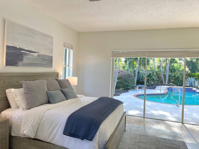 1627 Mayacoo Lakes Blvd, West Palm Beach, FL 33411 - bedroom with access to exterior and a textured ceiling