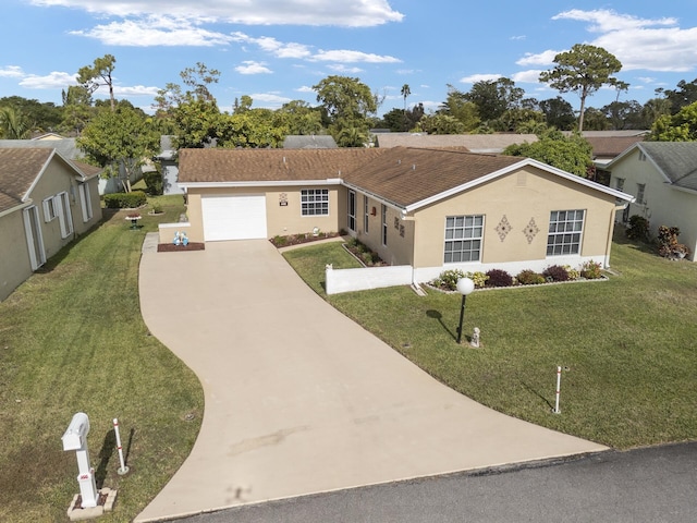 ranch-style house featuring a garage and a front lawn