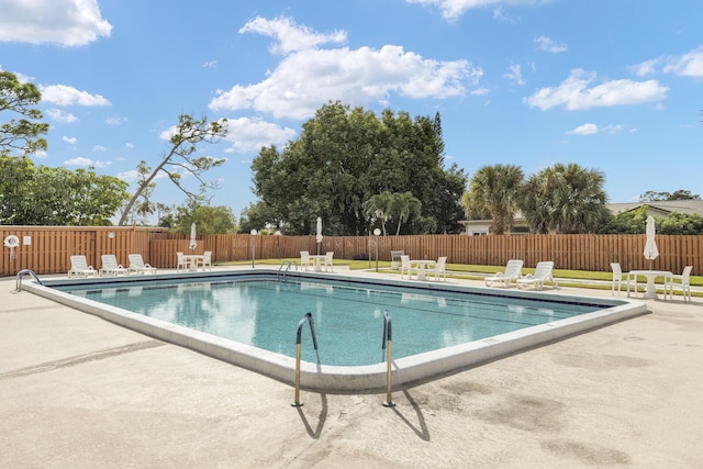 view of swimming pool featuring a patio area