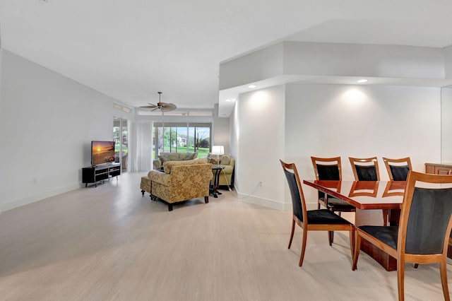 dining area with ceiling fan and light hardwood / wood-style floors