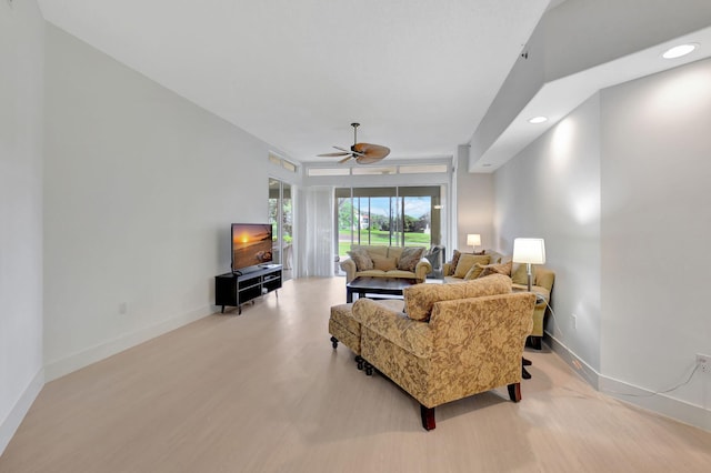 living room featuring light hardwood / wood-style flooring and ceiling fan