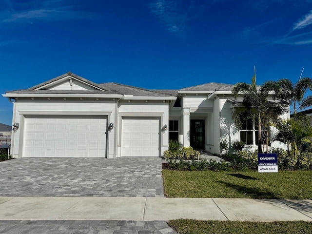 view of front facade with a garage and a front lawn