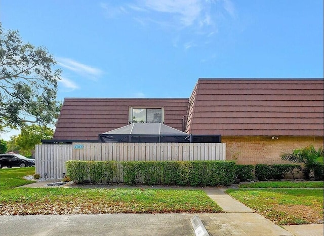 1707 17th Ln, Palm Beach Gardens, FL 33418 - view of property exterior featuring brick siding and mansard roof