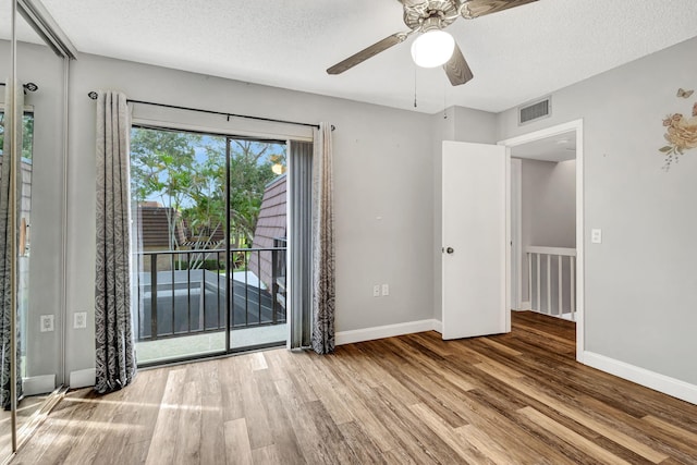 spare room featuring hardwood / wood-style floors, a textured ceiling, and ceiling fan