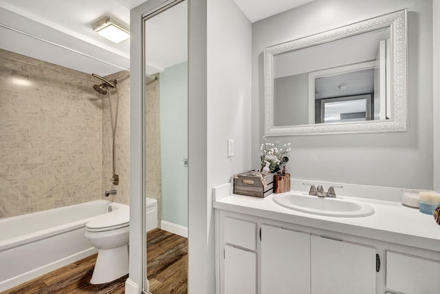 full bathroom with toilet, hardwood / wood-style floors, vanity, and tiled shower / bath