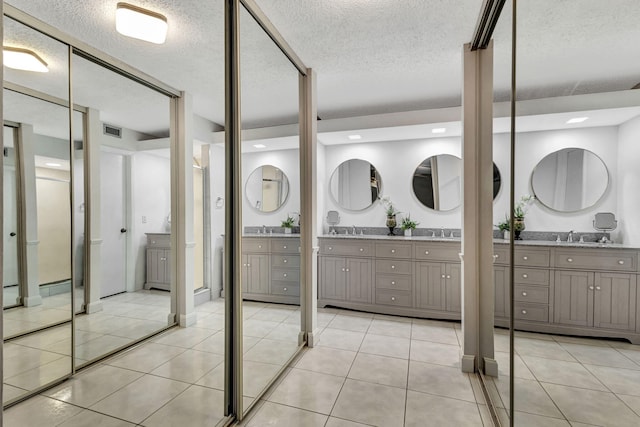 1707 17th Ln, Palm Beach Gardens, FL 33418 - bathroom featuring vanity, a textured ceiling, and tile patterned flooring