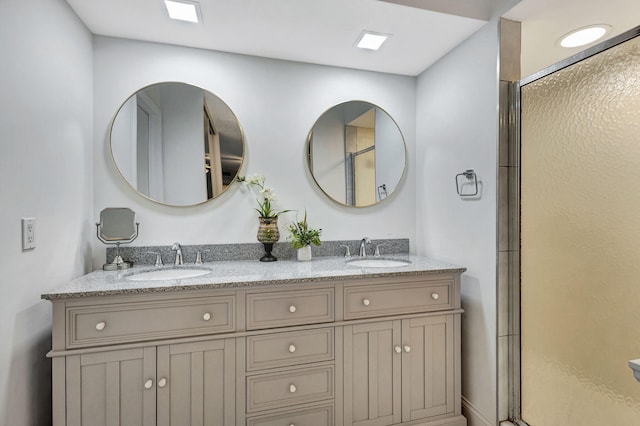 bathroom featuring vanity and an enclosed shower