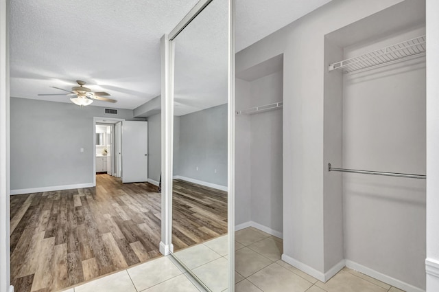 interior space with light wood-type flooring and ceiling fan