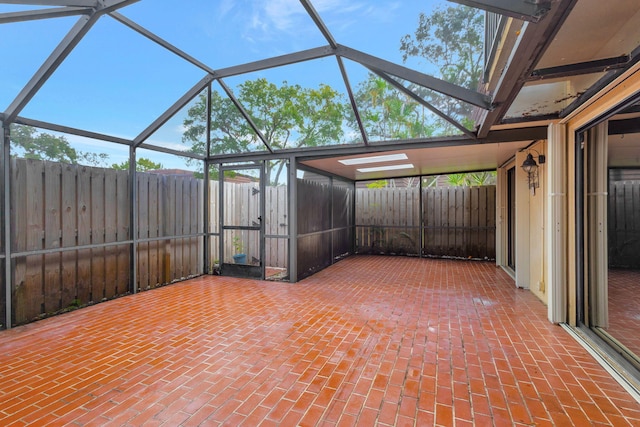 view of patio featuring glass enclosure