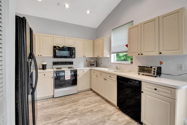 kitchen featuring black appliances, sink, light hardwood / wood-style flooring, vaulted ceiling, and decorative backsplash