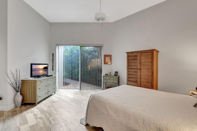 bedroom featuring access to exterior, ceiling fan, and light hardwood / wood-style flooring