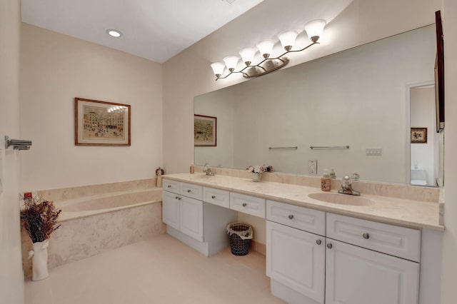 bathroom featuring tiled bath and vanity