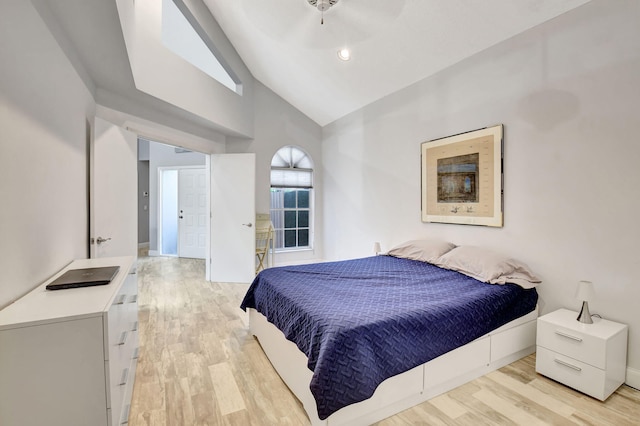 bedroom with ceiling fan, light wood-type flooring, and high vaulted ceiling