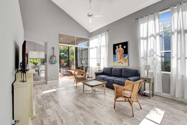 living room with light wood-type flooring, high vaulted ceiling, and ceiling fan