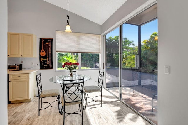 dining area featuring light hardwood / wood-style flooring and lofted ceiling