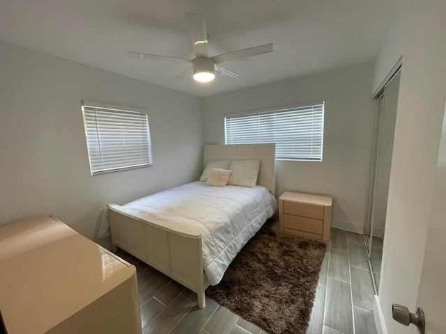 bedroom with ceiling fan, light hardwood / wood-style floors, and a closet