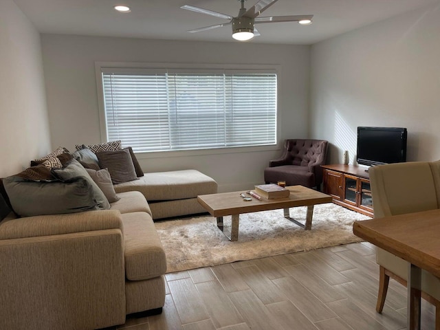 living room featuring ceiling fan and light hardwood / wood-style flooring