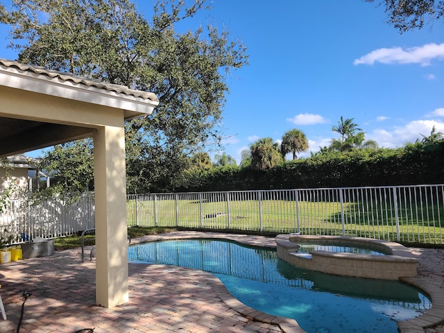 view of pool with a patio area and an in ground hot tub