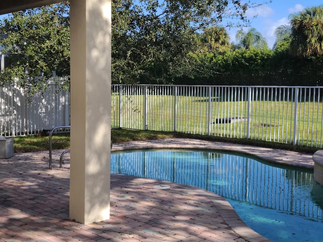 view of pool featuring a yard and a patio area