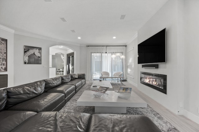 living room with light hardwood / wood-style flooring and ornamental molding