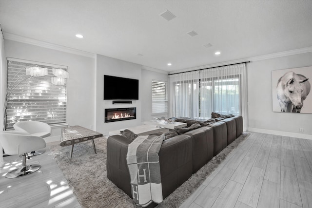 living room with light hardwood / wood-style floors and ornamental molding