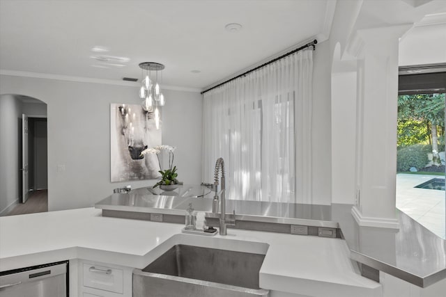 kitchen featuring dishwasher, white cabinets, crown molding, sink, and hanging light fixtures