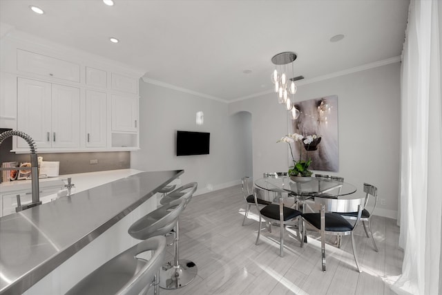 dining space with crown molding