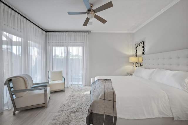 bedroom featuring light hardwood / wood-style flooring, ceiling fan, and crown molding