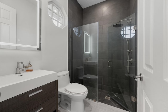 bathroom featuring walk in shower, vanity, and toilet