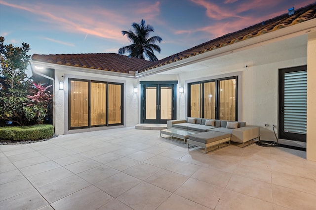 exterior space with outdoor lounge area, a patio, and french doors