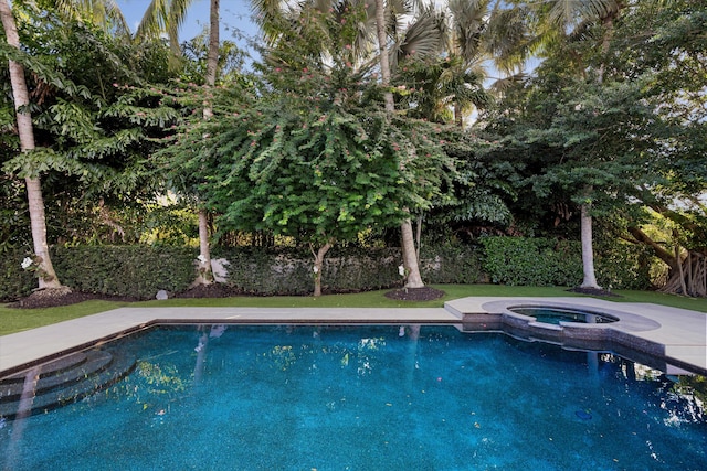 view of pool featuring an in ground hot tub