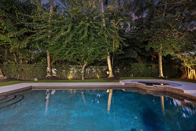 view of swimming pool with an in ground hot tub