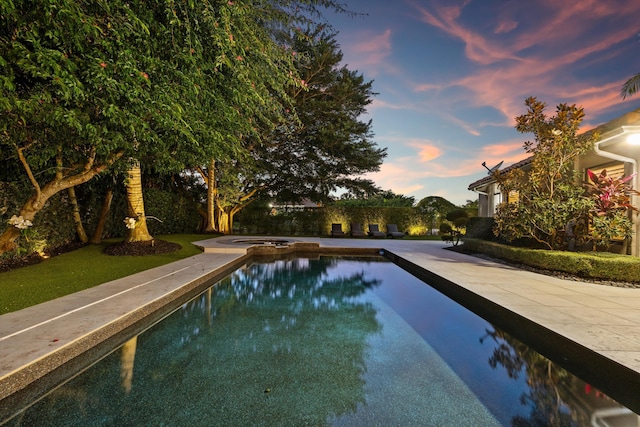 view of pool at dusk